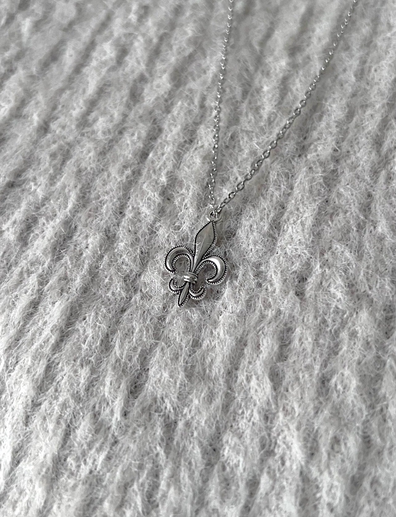 Silver Fleur Icon pendant by Caelis Cole featuring intricate floral design and polished finish.